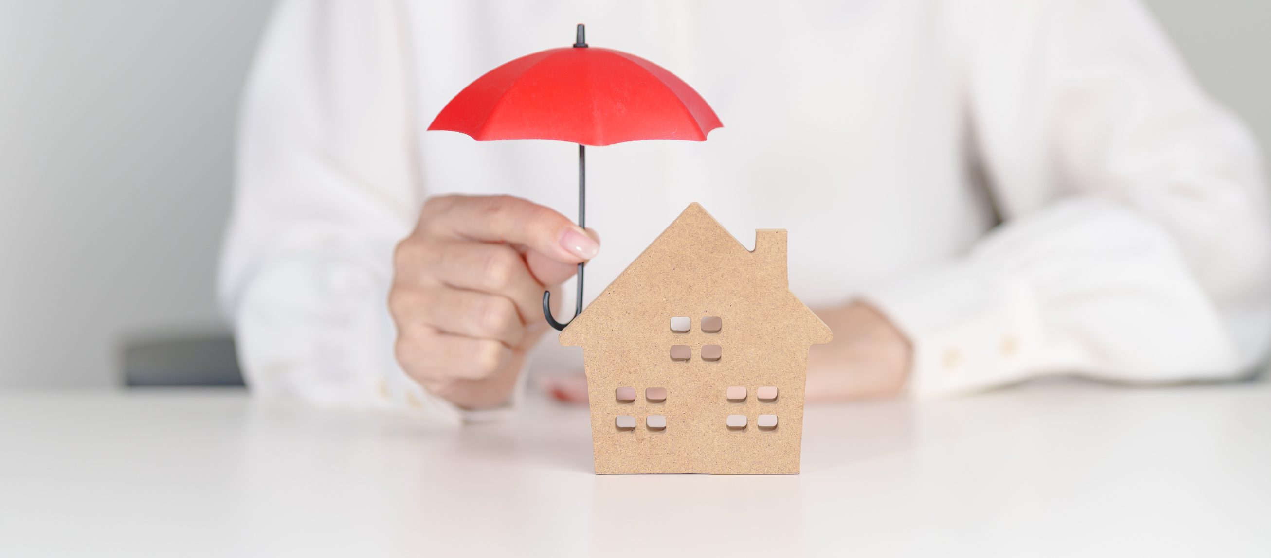 Protecting house with red umbrella