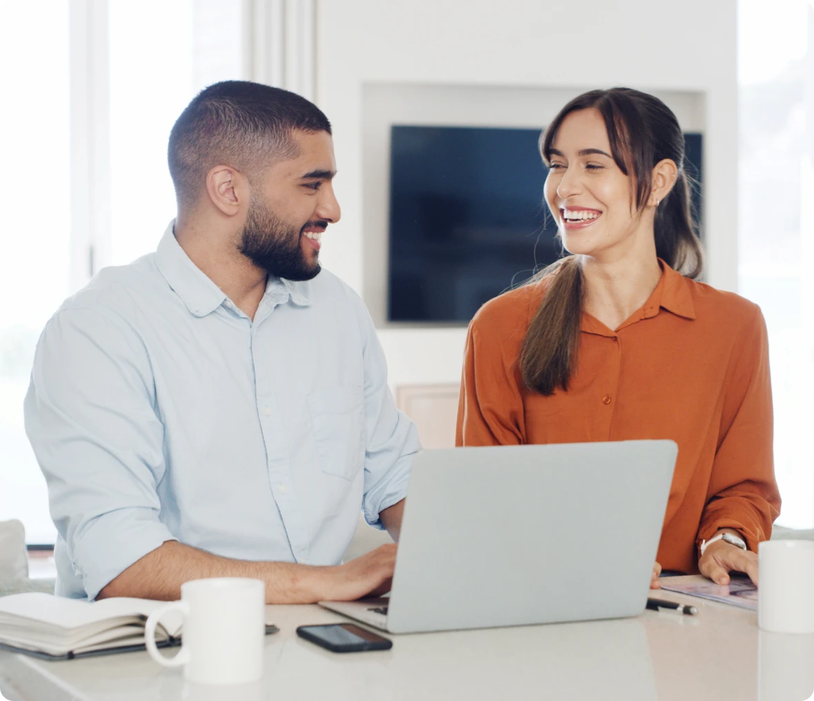 Happy coworkers collaborating at desk