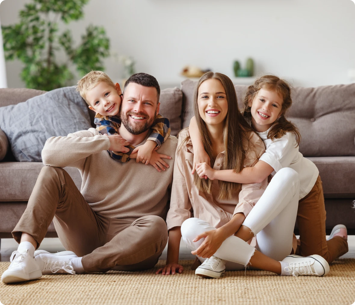 Smiling family posing in cozy home