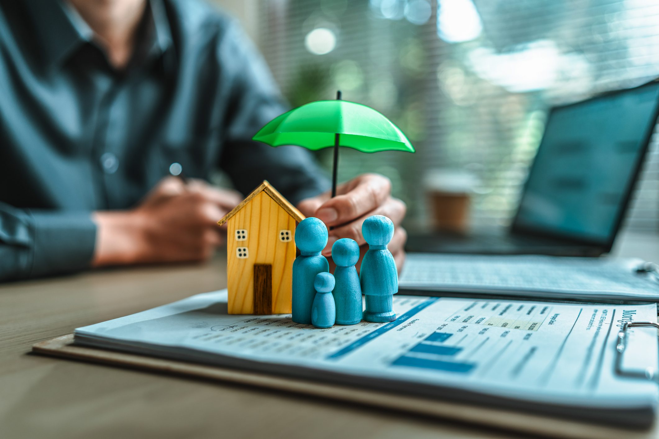 Protecting family with house and umbrella
