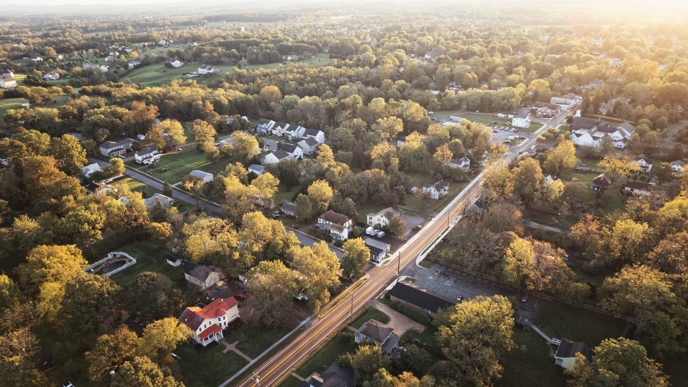 Scenic landscape with houses and road.