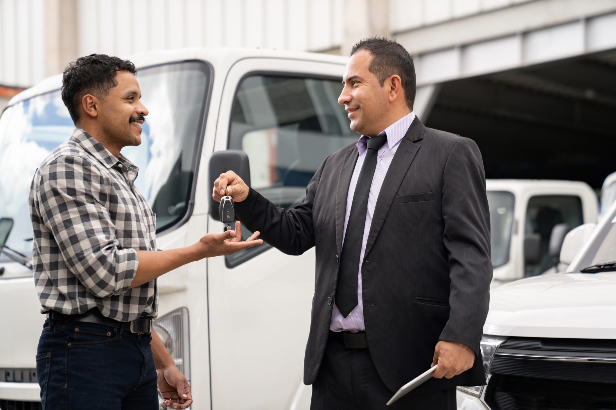Man receiving truck keys from salesman